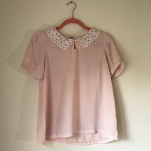 Blush pink blouse with embroidered details on neck